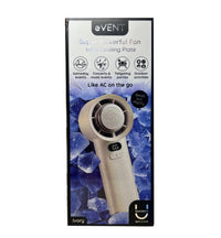 The Fashionit Event Ivory Handheld Fan with Cooling Plate is showcased in its box against an icy blue background, featuring a stylish ivory finish and a round cooling plate. Text emphasizes its suitability for events, parties, concerts, and outdoor activities.