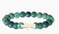 The fahlo Charge - Oasis Rhino bracelet features round turquoise beads and a central white bear-shaped bead, inspired by rhino conservation, shown on a white background.