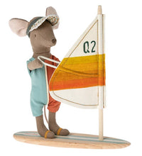 Wearing a visor and romper, the Maileg Beach mice, Surfer big brother stands on a surfboard holding a small sail marked with Q2 and orange-yellow stripes. This charming toy from Maileg is perfect for imaginative seaside adventures and beach-themed play.