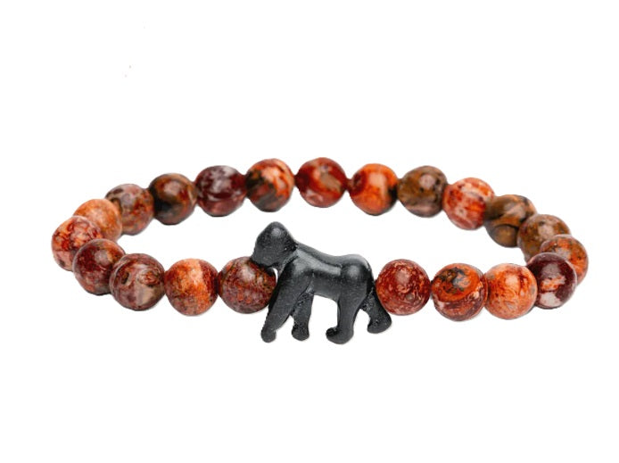 The Traverse - Mountain Stone Gorilla bracelet by fahlo features round, reddish-brown marbled beads and a central black gorilla-shaped charm—ideal for wildlife conservation supporters and gorilla tracking fans.