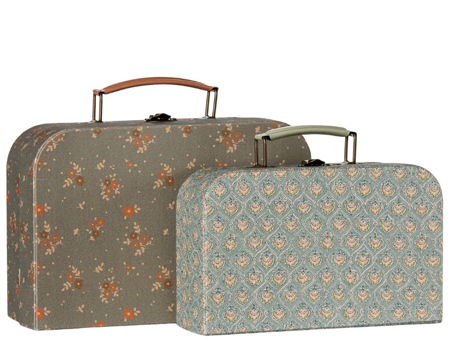 Two vintage-inspired Maileg suitcases with handles—including one larger case featuring a brown floral pattern and one smaller case adorned with a blue and beige geometric design—stand side by side against a white background. Perfect as the charming Maileg Suitcase set, 2 pcs - Michette for pretend play or as collectible pieces from Maileg.
