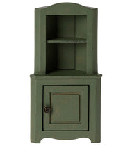 The Maileg Corner Cabinet, Mouse - Dark Green by Maileg is a small green wooden cabinet with a shelf and a closed door, perfect for dollhouses or Maileg Mouse setups, featuring a rustic, distressed finish for charming miniature storage.