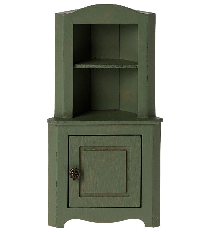 The Maileg Corner Cabinet, Mouse - Dark Green by Maileg is a small green wooden cabinet with a shelf and a closed door, perfect for dollhouses or Maileg Mouse setups, featuring a rustic, distressed finish for charming miniature storage.