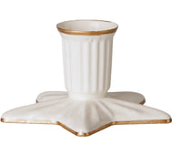 The Maileg Candle holder, Star, Large by Maileg is a white ceramic candle holder with vertical grooves and gold trim, featuring a wide, star-shaped base also edged in gold.