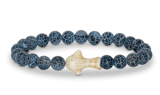 The Quest - Deep Blue Whale Shark bracelet by fahlo features round, dark blue beads with white crackle patterns and a cream-colored whale shark bead—an ideal accessory for supporting marine conservation.