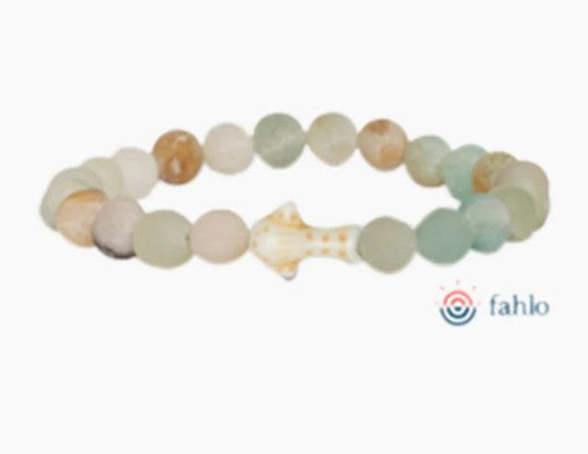 The fahlo Quest - Sky Stone Whale Shark bracelet features pastel round beads and a shark-shaped centerpiece, inspired by whale shark tracking and marine conservation, shown on a white background with the fahlo logo in the lower right corner.