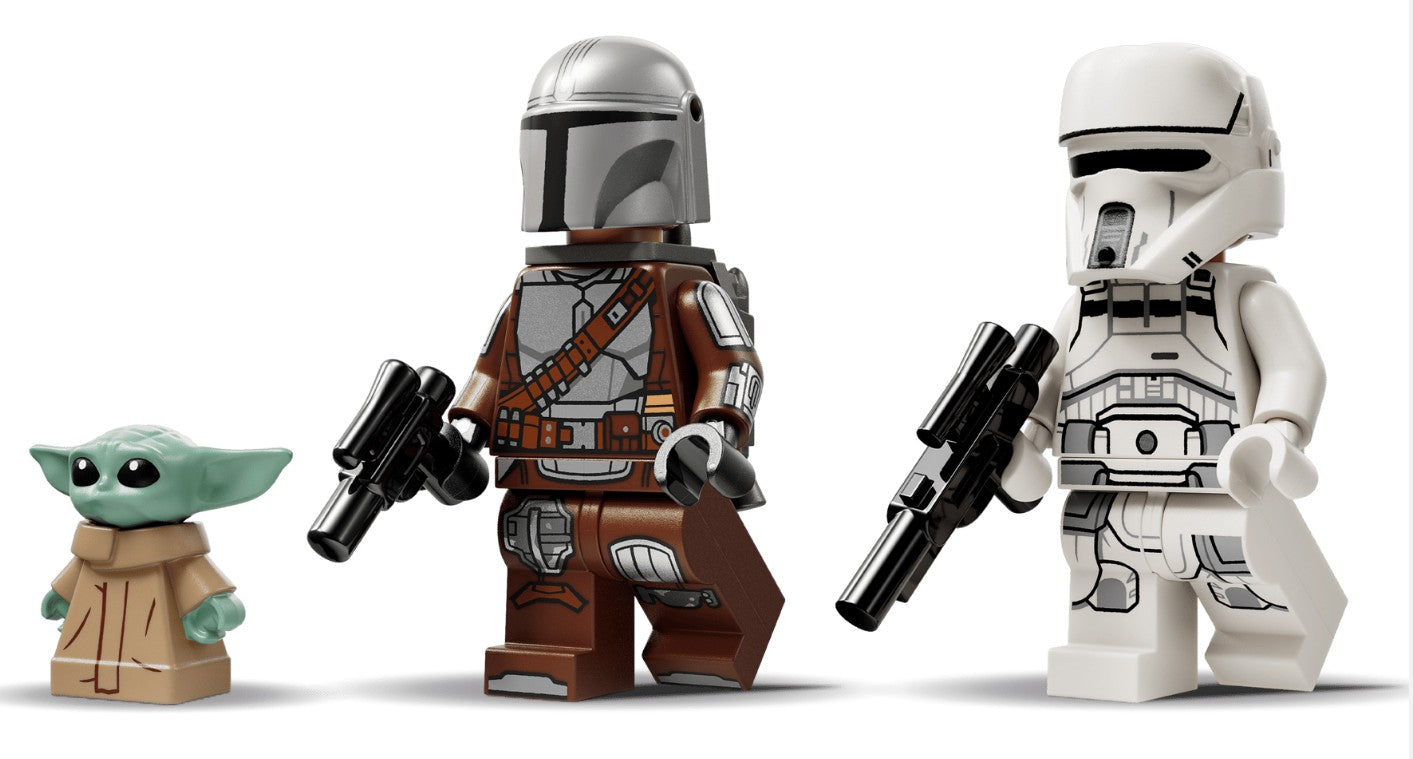 Grogu (green with large ears), the Mandalorian (wearing silver armor), and a white-armored stormtrooper—three iconic LEGO Star Wars minifigures, each holding a blaster—stand side by side on a white background. These legendary characters are ready for battle and make the perfect addition to your LEGO 75444 AT-RT Attack collection from LEGO.