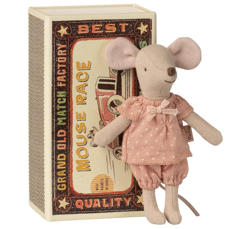 A Maileg Big Sister Mouse in a pink outfit stands before a decorative box styled like a vintage matchbox bed, branded Maileg.