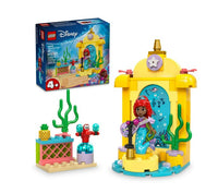 LEGO Ariel’s Music Stage by LEGO features an Ariel mini-doll with her signature red hair and blue dress, along with Sebastian the crab, underwater plant elements, and a yellow music stage—perfect for fans of The Little Mermaid—with the product box shown in the background.