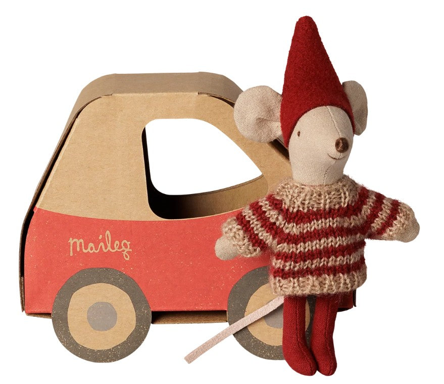 The Maileg Christmas mouse, Little sister in car box by Maileg features a petite mouse dressed in a red hat and striped sweater, standing before a charming cardboard and red toy car—perfect for holiday pretend play or as a delightful Christmas gift.
