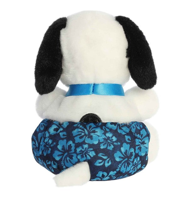 A plush 5" Surfer Palm Pals dog by Aurora, featuring black ears, a blue ribbon, and blue floral-print shorts, sits facing away—an ideal beach toy for any surf-loving collector.