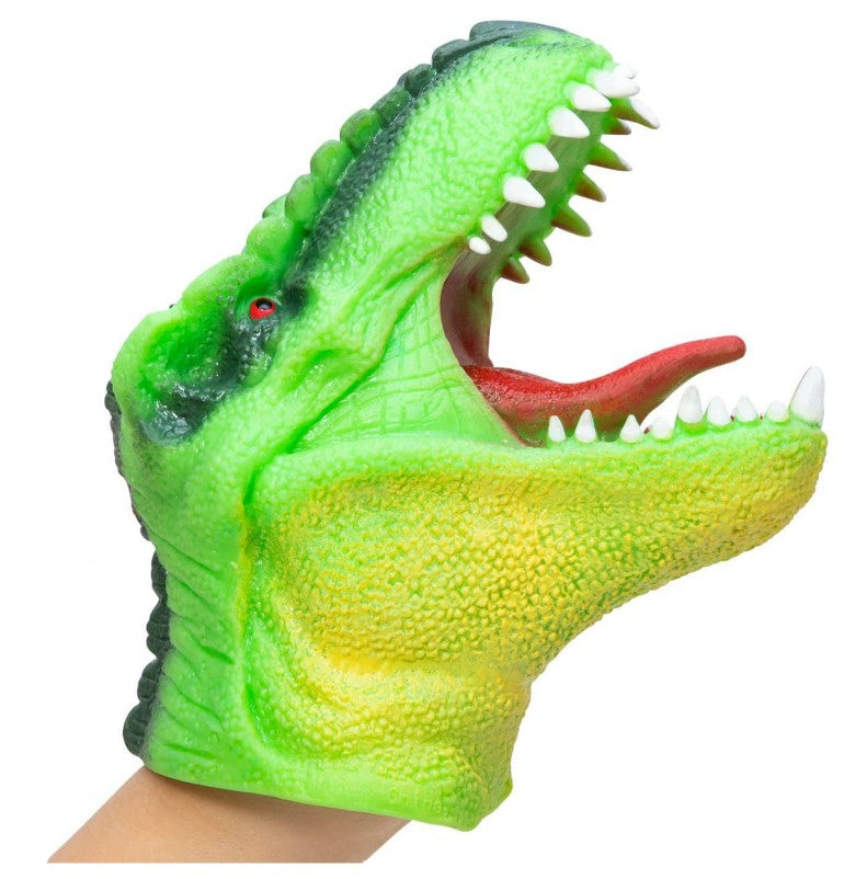 A person's hand is inside the Schylling Toys Dinosaur Hand Puppet, which features a green design with an open mouth displaying white teeth and a red tongue—perfect for imaginative play and storytelling.