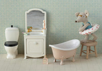Maileg's Beach Mouse With Float, Little Sister - Red Dots sits ready for seaside fun, complete with glasses and swim ring—perfect for imaginative play in your little one's whimsical bathroom scene.