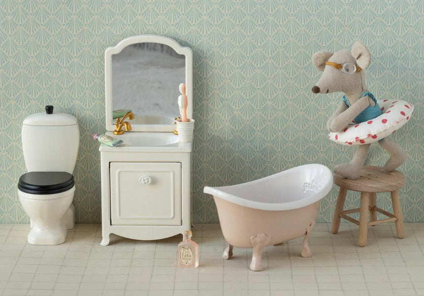 Maileg's Beach Mouse With Float, Little Sister - Red Dots sits ready for seaside fun, complete with glasses and swim ring—perfect for imaginative play in your little one's whimsical bathroom scene.