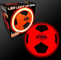A glowing red and black Pro Glow Light-Up Soccer Ball No. 5 by Thin Air Brands, LLC sits next to its box, both radiating a vivid red light that showcases the ball’s striking illumination feature.