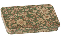 The Maileg Metal box with sliding lid - Blossom - Blue features a charming rectangular design adorned with a delicate blue background and beige floral pattern, making it the perfect keepsake box for storing your treasured mementos.