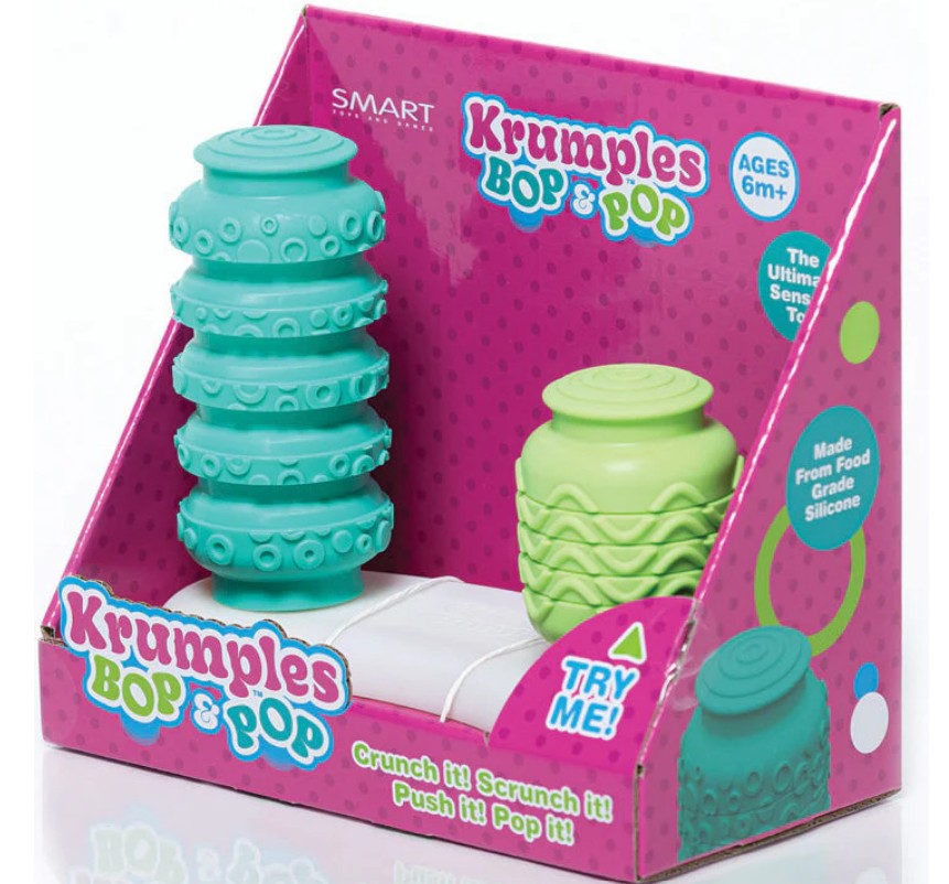 The Smart Toys Krumples Bop & Pop! Green/Teal display box includes two textured silicone sensory toys for ages 6 months+, with playful packaging, a Try Me! button, and encourages active family play.