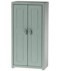 The Maileg Closet, Mouse - Soft Blue by Maileg is a tall mouse-sized closet with two paneled doors and round knobs, perfect for dollhouse furniture or storing Maileg Mouse accessories, displayed against a plain white background.