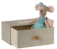The Maileg Dance Mouse In Daybed, Little Sister by Maileg features a petite mouse in a blue dress and headband, resting on a pillow inside a striped decorative box with a gold knob—ideal for creative play or as an adorable room accent.