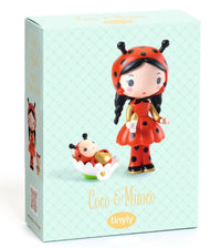 The DJECO Tinyly Coco & Minico toy box by DJECO features a charming ladybug-themed Tinyly figurine with black hair and a red dress, accompanied by a matching collectible figure resting in a white flower-shaped cradle—perfect for imaginative storytelling.