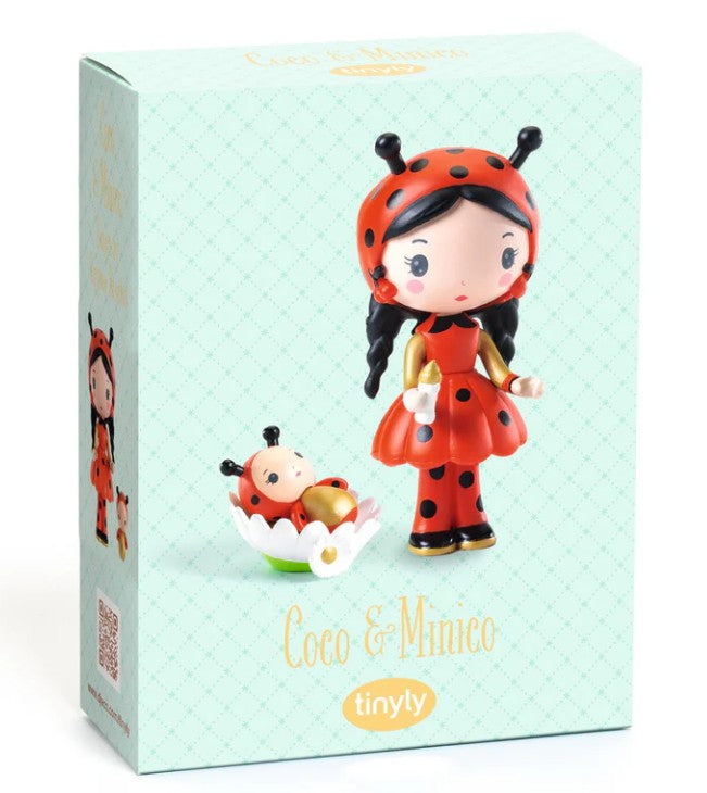 The DJECO Tinyly Coco & Minico toy box by DJECO features a charming ladybug-themed Tinyly figurine with black hair and a red dress, accompanied by a matching collectible figure resting in a white flower-shaped cradle—perfect for imaginative storytelling.