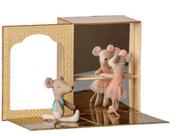 The Maileg Ballet mice in dance studio, Little sister and brother set by Maileg features three toy mice—two dressed in pink and one in blue—posing at the barre inside a ballet-themed miniature studio with gold-patterned walls and a mirror, inspiring imaginative play.