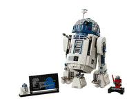 This LEGO R2-D2 collectible display model by LEGO features a meticulously crafted R2-D2, an information plaque, a miniature R2-D2 figure, and a red Star Wars minifigure with a red lightsaber, all displayed on a plain white background. Ideal for fans and collectors alike, this LEGO Star Wars building set brings iconic charm to any collection.