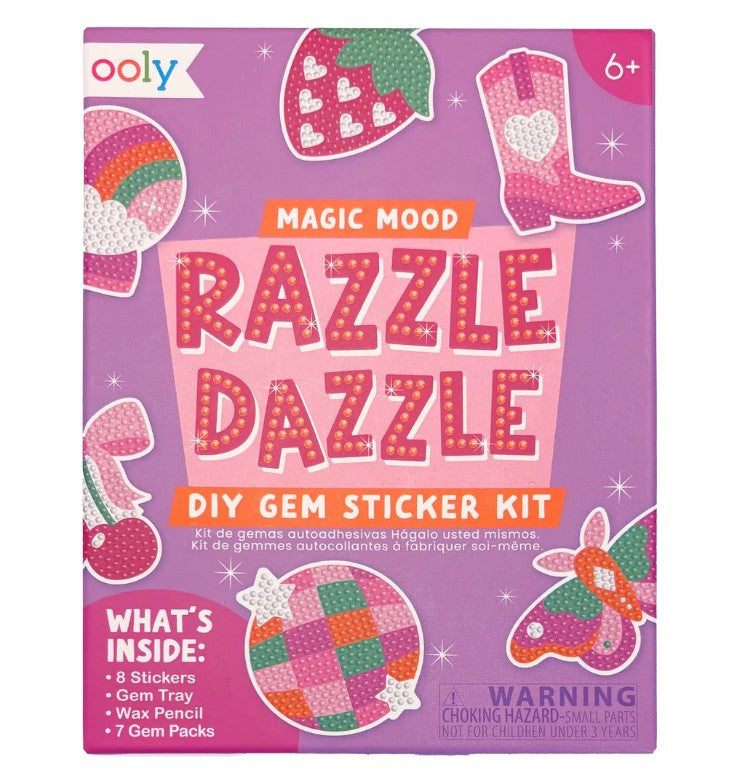 Front of an Ooly Mini Razzle Dazzle: D.I.Y. Gem Sticker Kit - Magic box in pink, featuring vibrant gem art designs, a list of included contents, and a small parts warning label. Ideal for crafting magical-themed creations. Recommended for ages 6 and up.