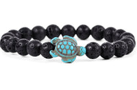 The Journey - Lava Stone Sea Turtle bracelet by fahlo features round black lava stones and a turquoise turtle bead, making it an ideal accessory for marine conservation enthusiasts.