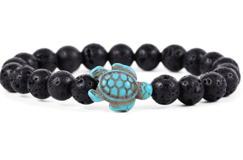 The Journey - Lava Stone Sea Turtle bracelet by fahlo features round black lava stones and a turquoise turtle bead, making it an ideal accessory for marine conservation enthusiasts.