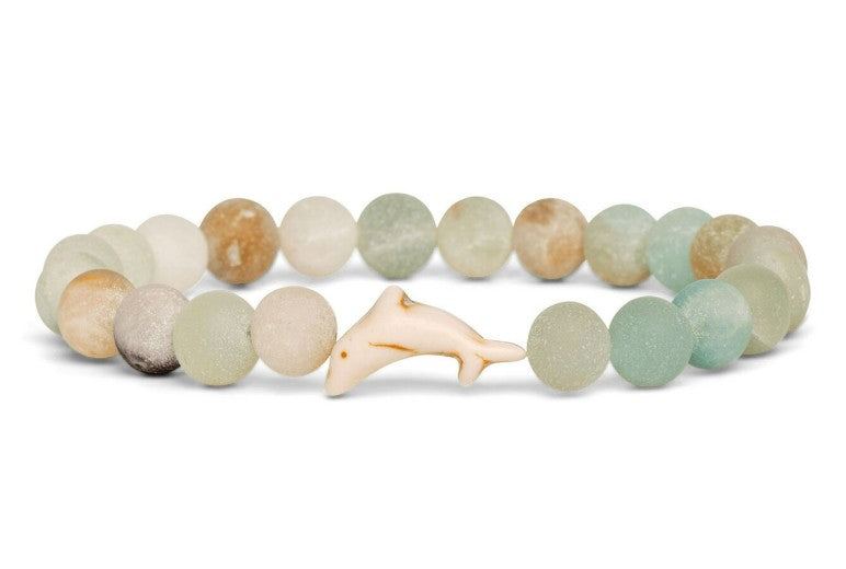 The Odyssey - Sky Stone Dolphin bracelet by fahlo features frosted pastel beads and a central white dolphin charm—a stylish accessory that subtly supports marine conservation.