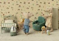 Two toy mice in a vintage-style room: one vacuums crumbs near the Maileg Folding Chair, Mouse - Mint, while the other stands by. The room features a bed, clock, snacks, wardrobe, and cowboy-themed wallpaper. Brand: Maileg.