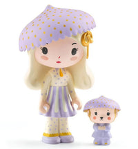 Two adorable DJECO Tinyly figurines—a girl and her small animal companion—both dressed in pale purple polka-dotted outfits and matching mushroom-shaped hats with yellow spots, stand side by side on a white background. Perfect for pairing with your DJECO Tinyly Jil Tinycar or creating whimsical miniature play scenes.