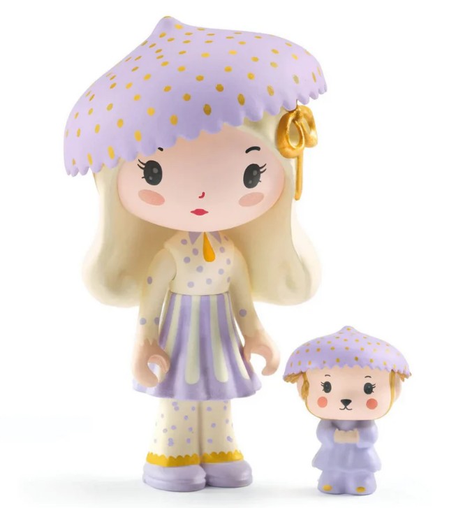 Two adorable DJECO Tinyly figurines—a girl and her small animal companion—both dressed in pale purple polka-dotted outfits and matching mushroom-shaped hats with yellow spots, stand side by side on a white background. Perfect for pairing with your DJECO Tinyly Jil Tinycar or creating whimsical miniature play scenes.