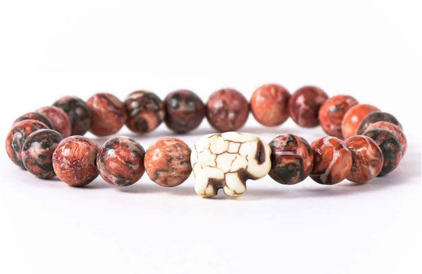 The fahlo Expedition - Desert Stone Elephant bracelet features polished red and black marbled beads with a central white elephant-shaped bead, displayed on a white background.