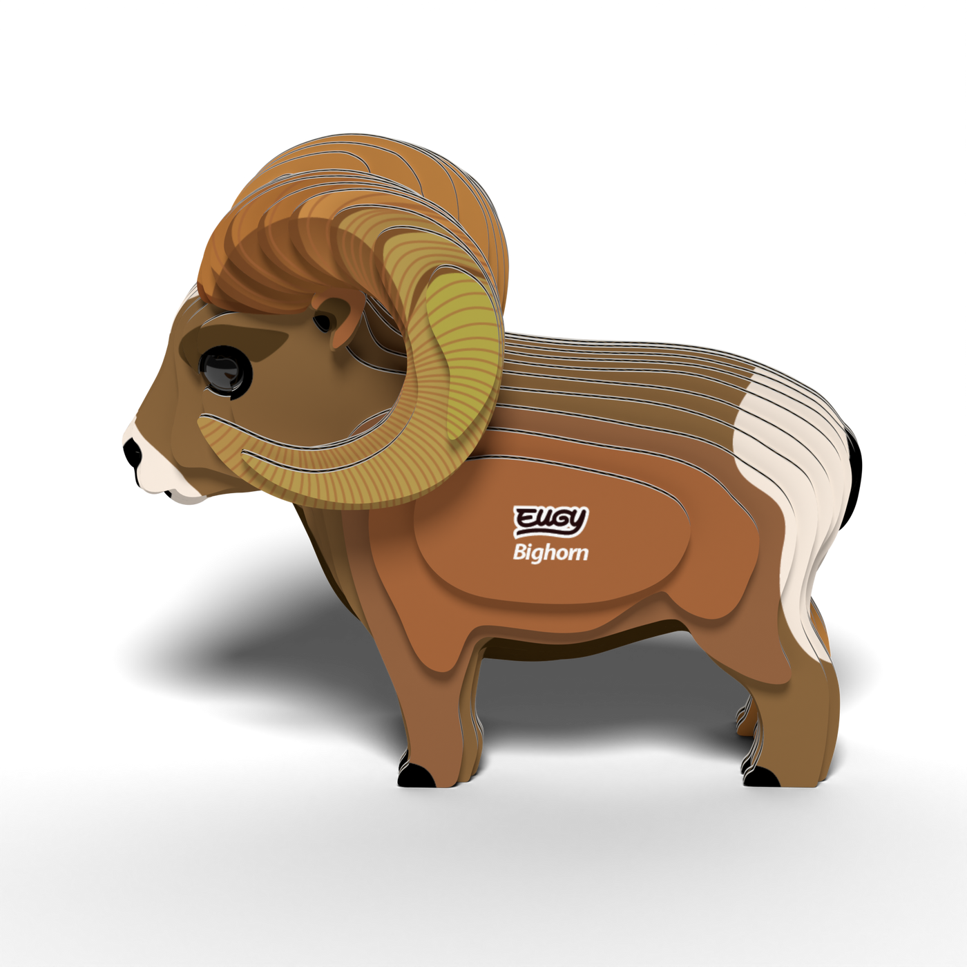 A 3D layered cardboard model of a bighorn sheep with large curved horns and distinctive white and brown markings, featuring the words "EUGY Bighorn" on its side, stands on a white surface. The EUGY Bighorn 3D Puzzle by Eugy is an eco-friendly toy that serves as both an educational STEM craft and a sustainable 3D puzzle.
