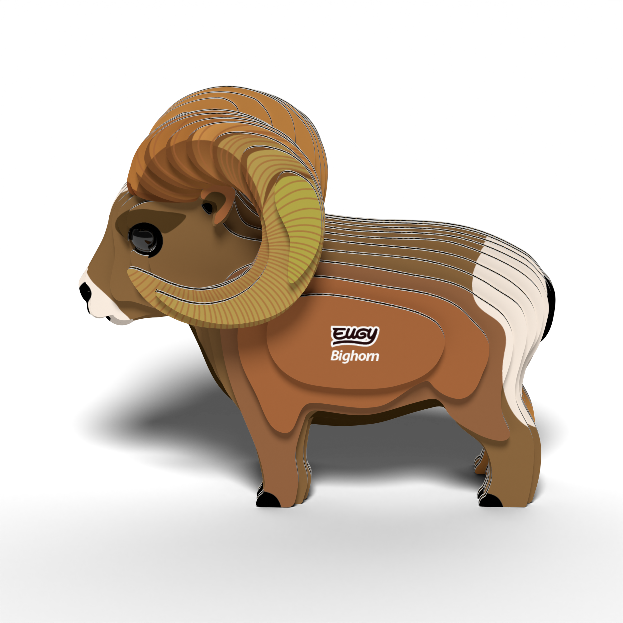 A 3D layered cardboard model of a bighorn sheep with large curved horns and distinctive white and brown markings, featuring the words "EUGY Bighorn" on its side, stands on a white surface. The EUGY Bighorn 3D Puzzle by Eugy is an eco-friendly toy that serves as both an educational STEM craft and a sustainable 3D puzzle.