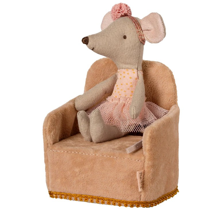 A Maileg Mouse plush, wearing a pink headband, polka-dot dress, and tutu, sits upright on the Maileg Folding Chair, Mouse - Powder by Maileg—a soft beige portable chair with gold trim at the bottom.