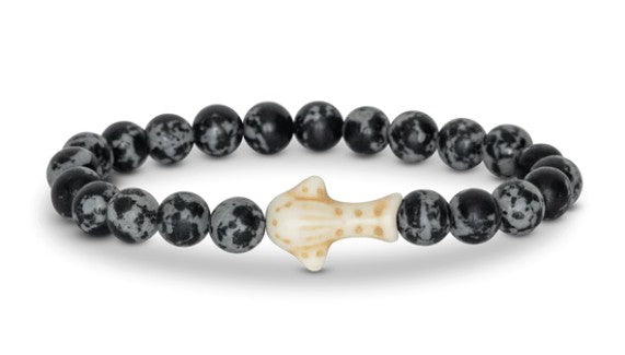 The fahlo Quest - Ocelli Stone Whale Shark bracelet features black and gray speckled beads and a beige, spotted whale shark centerpiece—an ideal accessory for marine conservation enthusiasts.