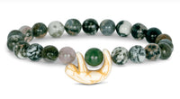 The fahlo Wander - Rainforest Green Sloth bracelet features round marbled green and white stones with a white and gold sloth charm—ideal for wildlife conservation enthusiasts.