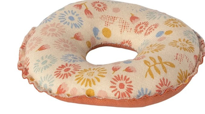 The Maileg Float, Small mouse - Flower by Maileg is a donut-shaped beige fabric cushion featuring colorful floral patterns in red, blue, and yellow, with a brown bottom edge and a center hole. This charming accessory is perfect as a miniature pool toy or for small mice.