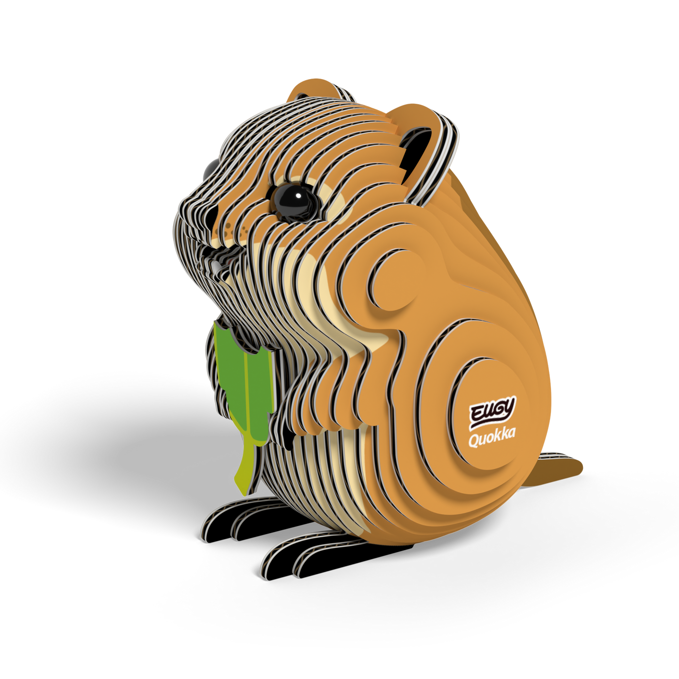 A small, eco-friendly cardboard model of a brown and tan quokka with black eyes, holding a green leaf. The EUGY Quokka 3D Puzzle by Eugy features a layered design and has "EUGY Quokka" printed on its side, displayed against a white background.