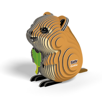 A small, eco-friendly cardboard model of a brown and tan quokka with black eyes, holding a green leaf. The EUGY Quokka 3D Puzzle by Eugy features a layered design and has "EUGY Quokka" printed on its side, displayed against a white background.