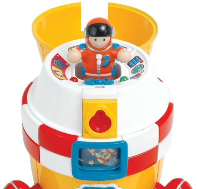 The Ronnie Rocket by Smart Toys is a vibrant yellow, red, and white playset with a round cockpit and an astronaut in an orange suit at the controls. Decorated with bright patterns, it’s perfect for imaginative play.