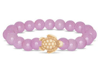Introducing the fahlo Journey - Lilac Glow Sea Turtle bracelet, featuring round lilac beads and a beige turtle-shaped charm—an ideal accessory for wildlife conservation enthusiasts.