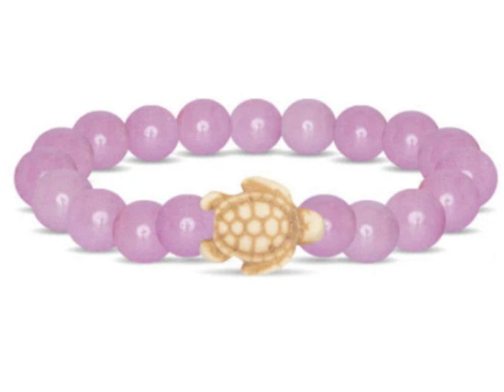 Introducing the fahlo Journey - Lilac Glow Sea Turtle bracelet, featuring round lilac beads and a beige turtle-shaped charm—an ideal accessory for wildlife conservation enthusiasts.