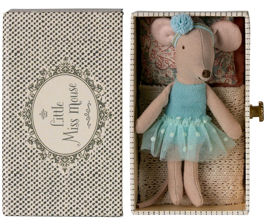 The Maileg Dance Mouse In Daybed, Little Sister by Maileg, features a Little Sister mouse in a blue dress and headband resting on a cozy daybed with bedding and pillow—perfect for imaginative play.