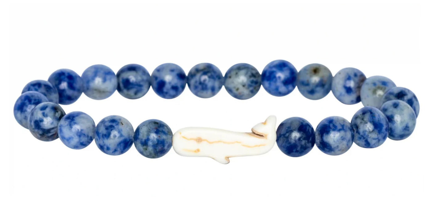 The fahlo Wayfare - Coastal Blue Whale bracelet features round blue beads and a white whale centerpiece—ideal for marine conservation enthusiasts.
