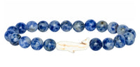 The fahlo Wayfare - Coastal Blue Whale bracelet features round blue beads and a white whale centerpiece—ideal for marine conservation enthusiasts.