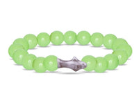 The fahlo Voyage - Sage Glow Shark is a stretchy, glow-in-the-dark bracelet made of round, light green beads with a unique shark-shaped centerpiece.